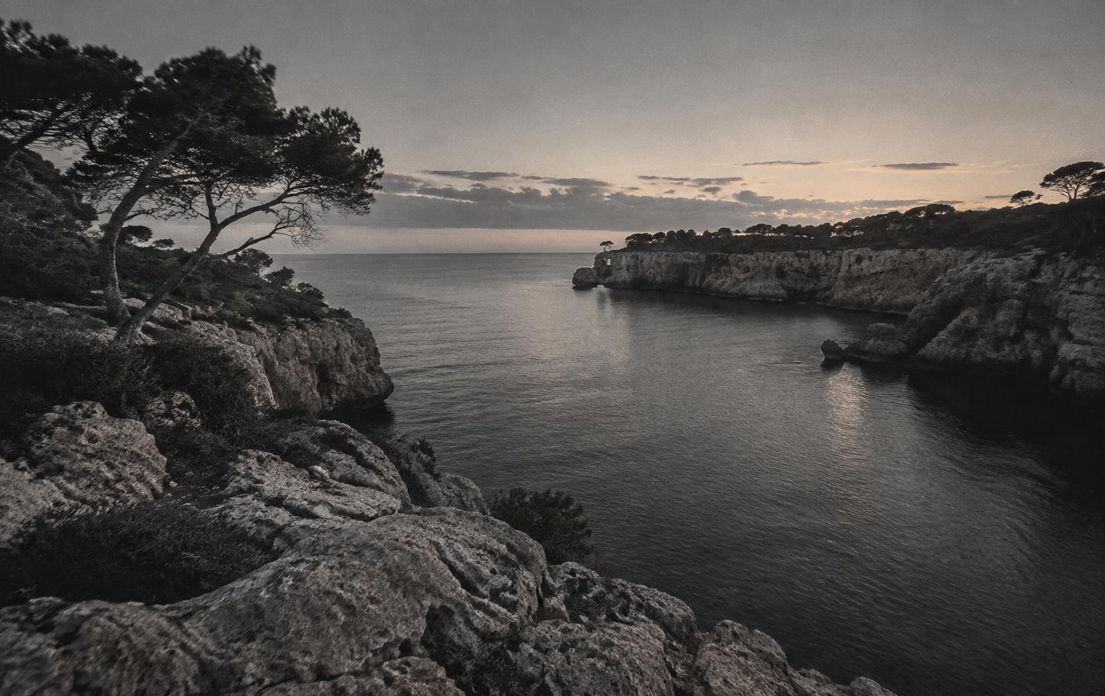 Rocky Mediterranean cove at dusk